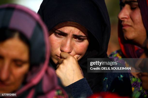 Syrian Kurdish woman mourns during the funeral of fighters from the Kurdish People's Protection Units , who were killed during battles in the...