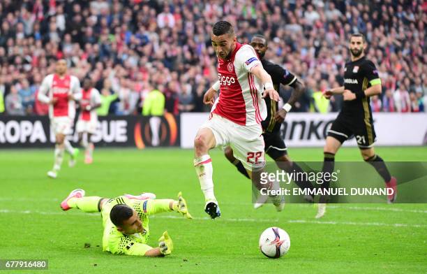 Lyon's Portuguese goalkeeper Anthony Lopes vies with Ajax midfielder Hakim Ziyech during UEFA Europa League semi-final, first leg, Ajax Amsterdam v...