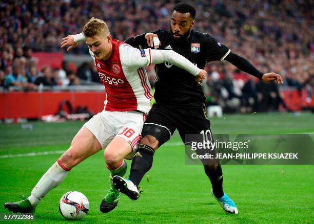 Ajax defender Matthijs de Ligt vies with Lyon's French forward Alexandre Lacazette during UEFA Europa League semi-final, first leg, Ajax Amsterdam v...