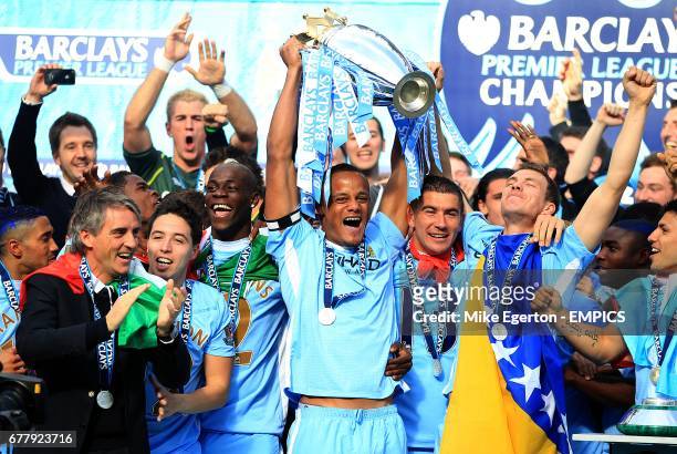 Manchester City's captain Vincent Kompany lifts the Barclays Premier League trophy