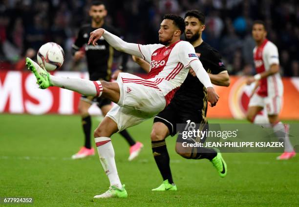 Ajax defender Jairo Riedewald vies with Lyon's French midfielder Nabil Fekir vie during UEFA Europa League semi-final, first leg, Ajax Amsterdam v...