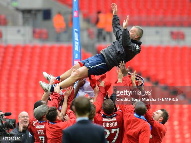 York City's manager Gary Mills is thrown in the air in celebration by his players after winning The Blue Square Bet premier Division Promotion Final