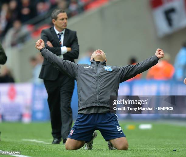 Luton Town's manager Paul Buckle stands dejected as York City's manager Gary Mills celebrates winning the Blue Square Bet Premier Division Promotion...
