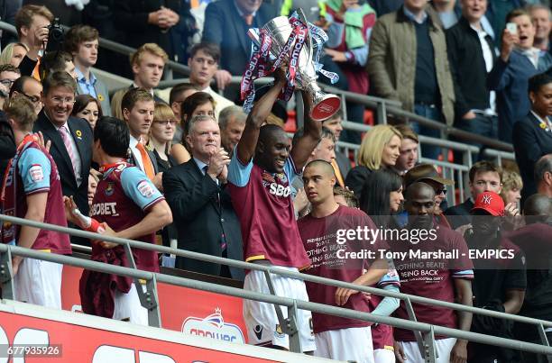 West Ham United's Carlton Cole celebrates with the Championship Play-Off trophy after victory over Blackpool