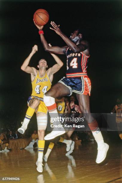 Earl Monroe of the Baltimore Bullets shoots against Jerry West of the Los Angeles Lakers circa 1967 at the Great Western Forum in Inglewood,...