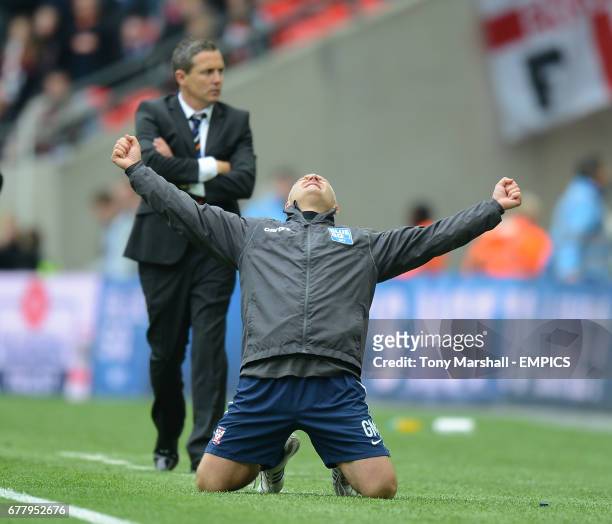 Luton Town's manager Paul Buckle stands dejected as York City's manager Gary Mills celebrates winning the Blue Square Bet Premier Division Promotion...