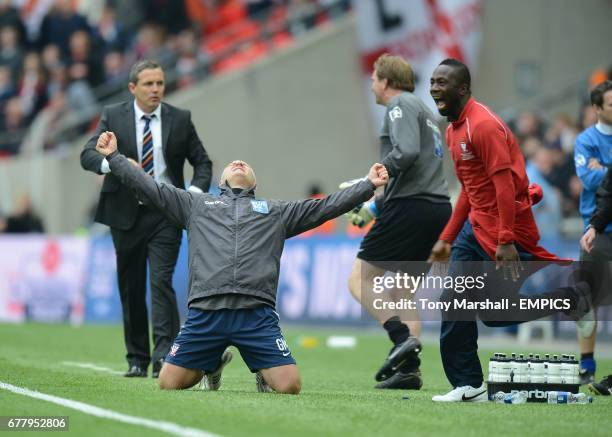 Luton Town's manager Paul Buckle stands dejected as York City's manager Gary Mills celebrates winning the Blue Square Bet Premier Division Promotion...