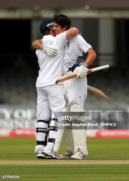 England's Alastair Cook celebrates reaching his century of 100 runs during their second innings with team mate Ian Bell