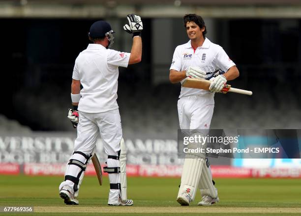 England's Alastair Cook celebrates reaching his century of 100 runs during their second innings with team mate Ian Bell