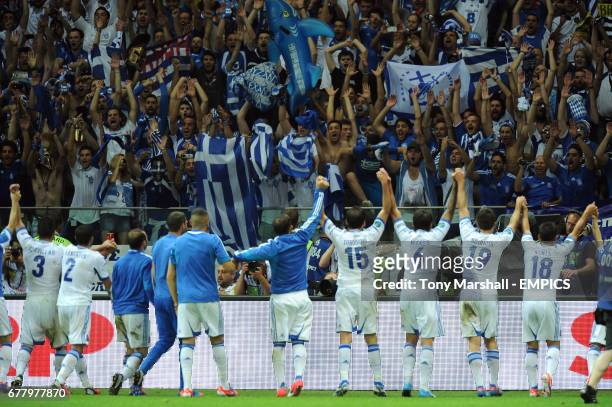 Greece's players celebrate their win and qualification for the knock out stage of Euro 2012 in front of their fans
