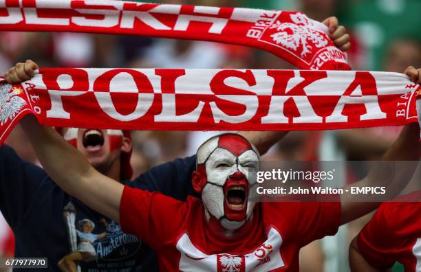 Poland fan shows his support for his team in the stands before the start of the match