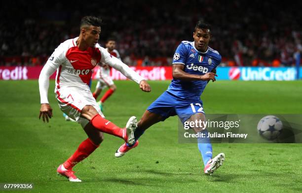 Simone Zaza of Juventus puts a cross in under pressure from Alex Sandro of Juventus during the UEFA Champions League Semi Final first leg match...