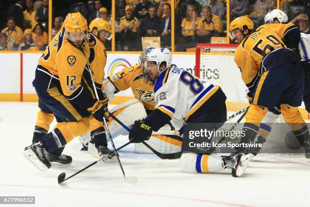 Nashville Predators center Mike Fisher clears the puck away from the stick of St. Louis Blues left wing Zach Sanford during Game Four of Round Two of...