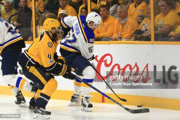 Nashville Predators defenseman Ryan Ellis challenges St. Louis Blues right wing David Perron for the puck during Game Four of Round Two of the...
