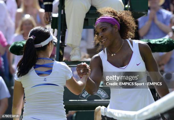 S Serena Williams is congratulated by China's Jie Zheng after winning their match on Centre Court