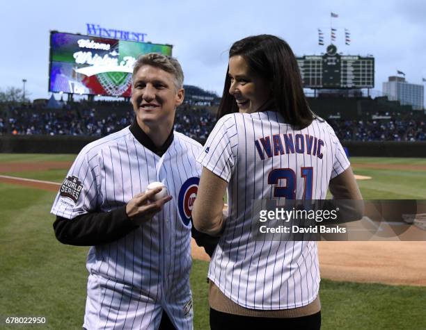 Former tennis player and French Open champion Ana Ivanovic and Chicago Fire Soccer player Bastian Schweinsteiger on the field before the game between...