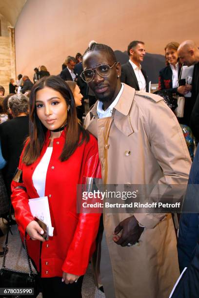 Football player Mamadou Sakho and his wife Majda attend the Chanel Cruise 2017/2018 Collection Show at Grand Palais on May 3, 2017 in Paris, France.