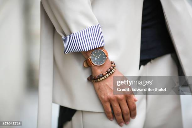 Theo Kimbaloula, fashion blogger, wears a Saudade Paris white jacket, a Saudade white large short, Asos black leather boots, a bracelet, and a Daniel...