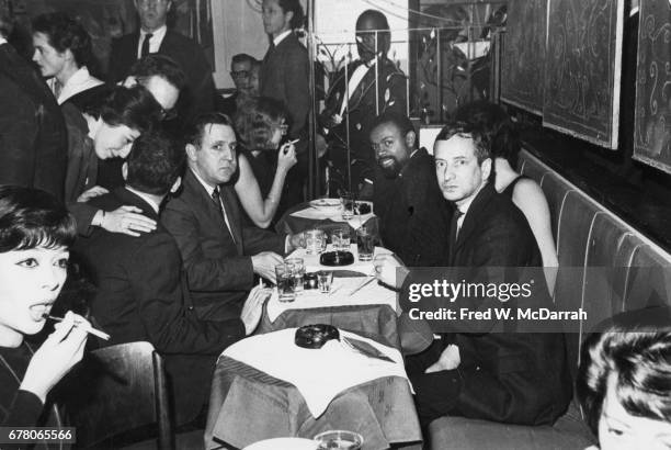 American poet and playwright LeRoi Jones and 8th Street Bookshop owner Ted Wilentz ) sit with unidentified others during a Grove Press event held at...