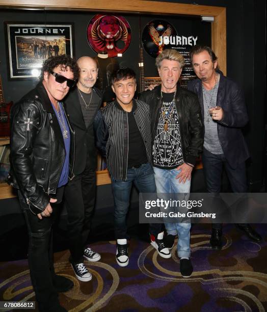 Guitarist Neal Schon, drummer Steve Smith, singer Arnel Pineda, bassist Ross Valory and keyboardist Jonathan Cain of Journey attend a memorabilia...