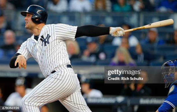 Matt Holliday of the New York Yankees hits a three-run home run in the first inning against the Toronto Blue Jays during a game at Yankee Stadium on...