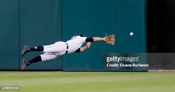 Center fielder Tyler Collins of the Detroit Tigers makes a diving attempt on a triple hit by Jose Ramirez of the Cleveland Indians during the fourth...