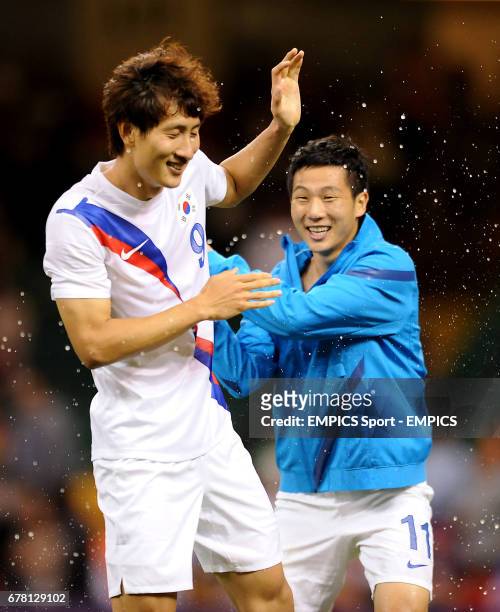 South Korea's Taehee Nam and Dongwon Ji celebrate after their side beat Japan to win the men's football Bronze medal match at the Millennium Stadium