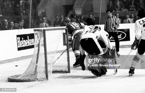 Vladimir Vikulov of the Soviet Union goes for the puck as goalie Ken Dryden of Canada defends the net during a game in the 1972 Summit Series circa...