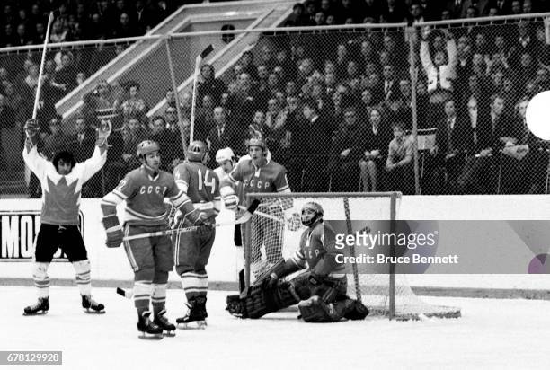 Parise and Red Berenson of Canada celebrate as Yevgeny Mishakov, Yuri Shatalov and goalie Vladislav Tretiak of the Soviet Union look dejected during...