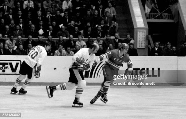 Gary Bergman and Pete Mahovlich of Canada defend against Valeri Kharlamov of the Soviet Union during a game in the 1972 Summit Series circa...