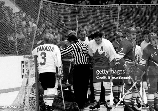 Pat Stapleton and Frank Mahovlich of Canada stand in the crease as goalie Vladislav Tretiak of the Soviet Union was knocked into his net during a...