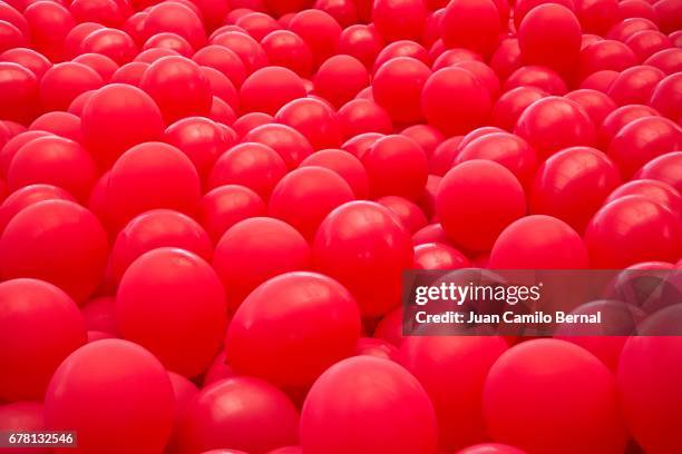 red balloons background - red balloon stock pictures, royalty-free photos & images