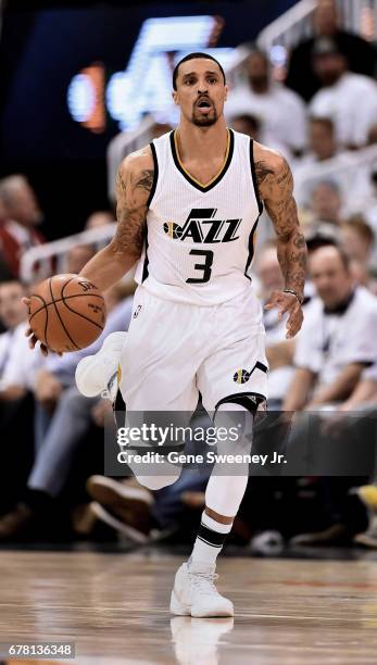 George Hill of the Utah Jazz brings the ball up court in the first half against the Los Angeles Clippers in Game Four of the Western Conference...