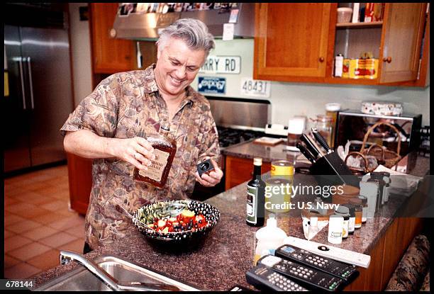 Author John Irving makes a salad in his kitchen June 27, 2001 at his home in Vernon, Vermont.