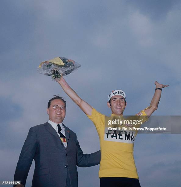 Belgian professional road race cyclist Eddy Merckx waves to the crowd after finishing in first place to win the 1969 Tour de France for the Faema...