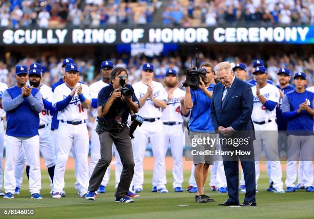 Former Los Angeles Dodgers announcer Vin Scully reacts as his plaque is unveiled during his induction into the Los Angeles Dodgers Ring of Honor at...