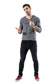 Expressive young casual man explaining and gesticulating with hands