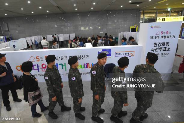 Soldiers wait in line to vote in advance at a polling station in Yongsan station in Seoul on May 4 ahead of next week's South Korean presidential...