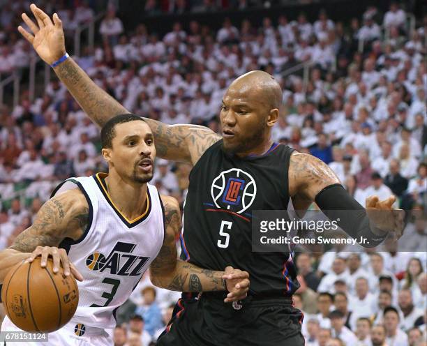 George Hill of the Utah Jazz drives to the basket past Marreese Speights of the Los Angeles Clippers in Game Four of the Western Conference...