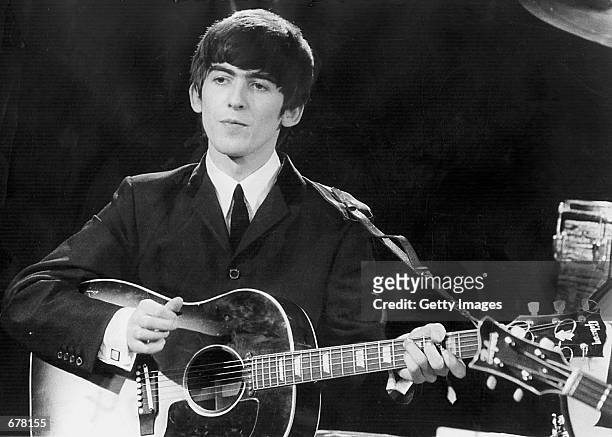 Beatles guitarist and singer George Harrison performs December 3, 1963 during a concert. It was reported November 8, 2001 that Harrison is undergoing...