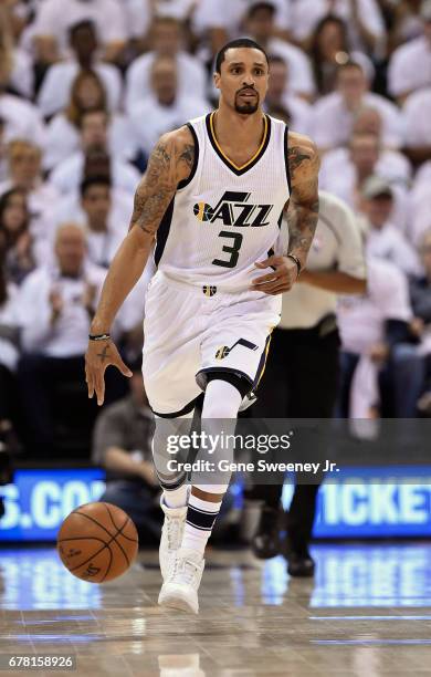 George Hill of the Utah Jazz brings the ball up court in the first half against the Los Angeles Clippers in Game Six of the Western Conference...