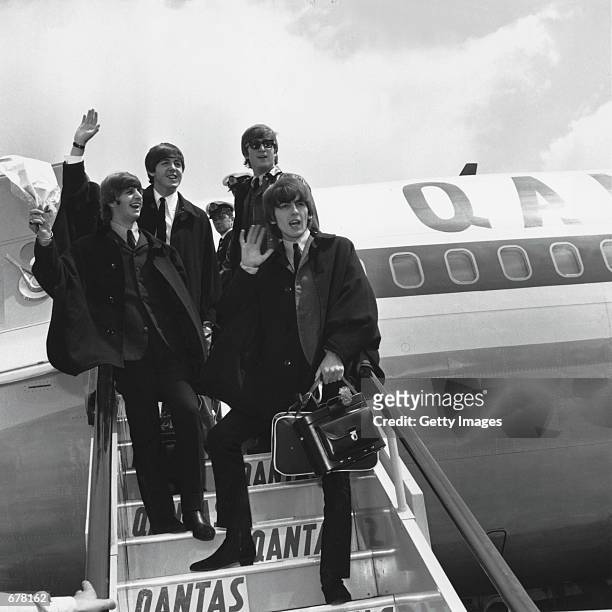 The Beatles Ringo Starr, Paul McCartney, John Lennon and George Harrison wave to fans July 2, 1964 as they return to London from a tour of Australia....