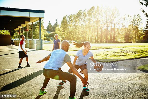 father defending daughter while playing basketball - blocking sports activity stock pictures, royalty-free photos & images