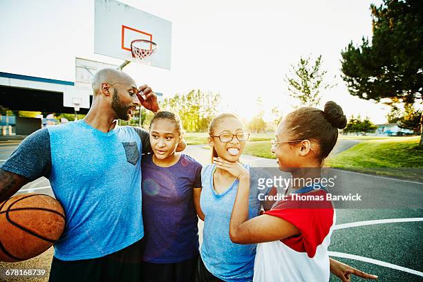 family hanging out after basketball game - pre game stockfoto's en -beelden