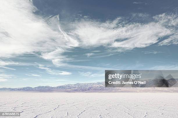 salt flat with distant mountains - view into land stock-fotos und bilder