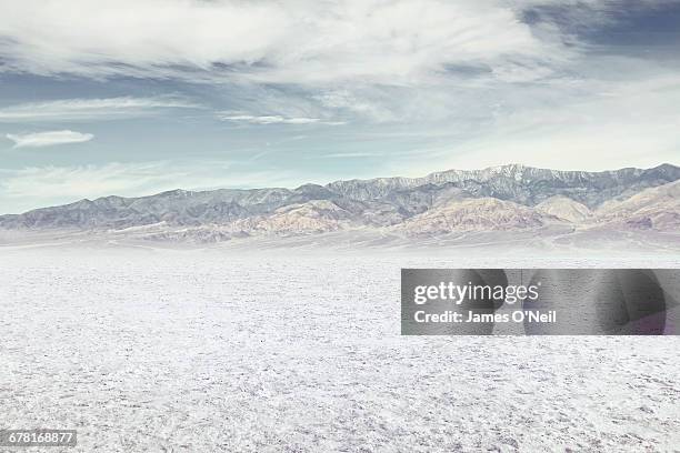 salt flat with distant mountains - salt flats stock pictures, royalty-free photos & images