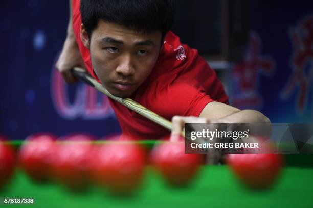 This photo taken on May 2, 2017 shows 19-year-old Xu Si playing a shot during practice at the World Snooker College in Beijing. At the World Snooker...