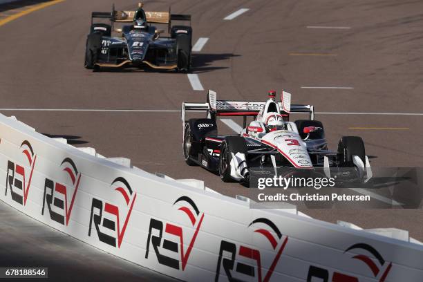 Helio Castroneves of Brazil, driver of the Team Penske Chevrolet drives out of the pitt area during practice for the Desert Diamond West Valley...