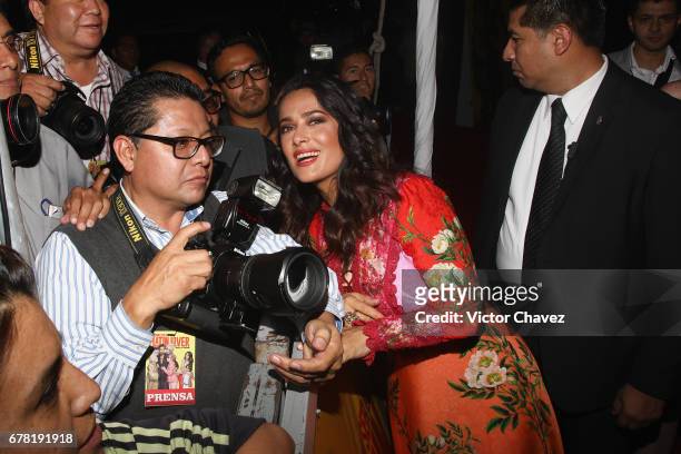 Actress Salma Hayek pose with a photographer during the "How To Be A Latin Lover" Mexico City premiere at Teatro Metropolitan on May 3, 2017 in...