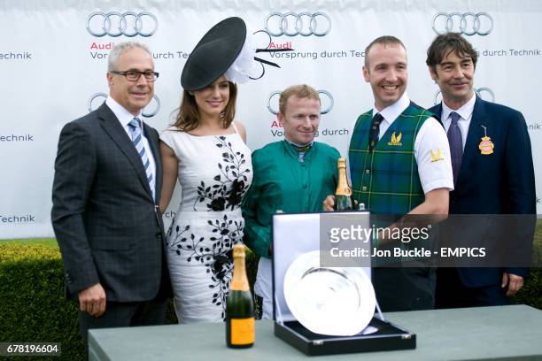 Jon Zammett Kelly Brook and Nat Parker present Jockey Joe Fanning with his award after Heavy Metal won the Audi Richmond Stakes